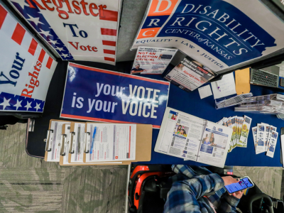 Photo of DRC's exhibit table featuring a sign that reads 